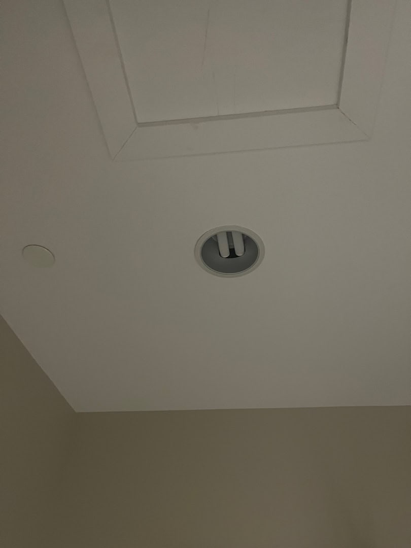 Recessed light fixture being installed in ceiling for LED pot light retrofit.