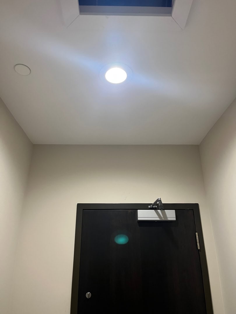 Recessed light fixture being installed in ceiling for LED pot light retrofit.